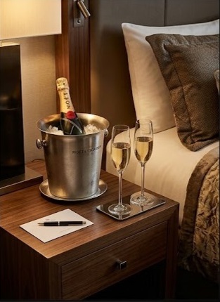Classy hotel room with champagne and flutes